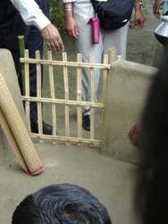 A simple wooden gate keeps kids away from the cooking fire.